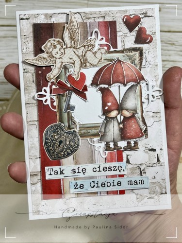 Romantyczna kartka walentynkowa handmade z postaciami pod parasolem, sercami i napisem „Tak się cieszę, że Ciebie mam”.